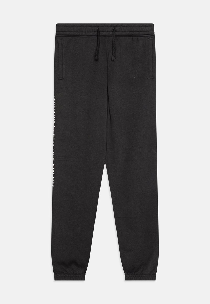 Schwarze Baumwoll-Jogginghosen mit elastischem Bund und Bündchen. Mit Seitentaschen und weißen Textdetails am linken Bein.