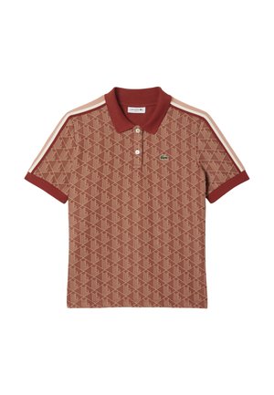 Red patterned polo shirt featuring short sleeves, a classic collar, and contrasting beige side stripes. Lacoste logo on the chest.
