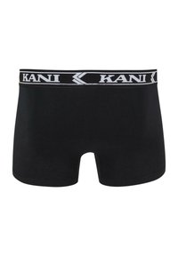 Schwarze Boxer-Shorts aus glattem Stoff mit einem breiten, elastischen Bund, der ein weißes 'KANI'-Logo zeigt. Einfaches, modernes Design.
