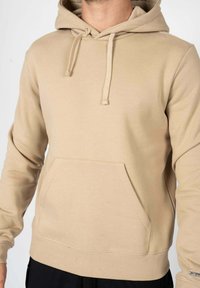 Felpa beige con cappuccio, in misto cotone, con tasca a marsupio, cordino, polsini e orlo ribassati, texture liscia, design casual.