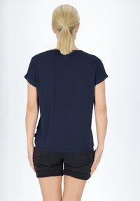 Navy blue short-sleeve T-shirt with rolled sleeves, simple rounded neckline, paired with black rolled hem shorts. Smooth fabric texture.