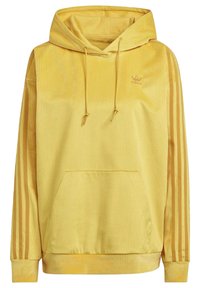 Gul hoodie i manchester med framficka, justerbar dragsko i huvan och tre vertikala ränder på ärmarna. Märkeslogga på bröstet.