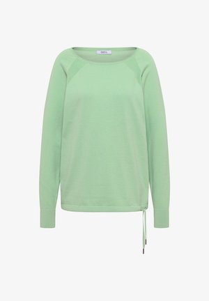 Jasnozielony, długi sweter z okrągłym dekoltem, ściągaczami na rękawach, fakturowanymi panelami na ramionach oraz sznurkiem do ściągania u dołu po prawej stronie.