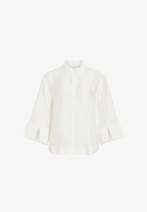 Blouse blanche à manches longues avec un col classique, une fermeture à boutons sur le devant et de larges poignets fendus.