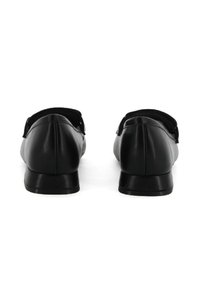 Scarpe di pelle nere con punta rotonda e tacco basso e solido. Texture liscia e design minimalista, senza accenti prominenti.