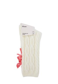 Calcetín blanco de punto con puño acanalado y acento de lazo rosa en el lateral. Etiqueta con el nombre de la marca "Etam" y detalles del producto adjunta.