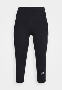 Leggings neri a vita alta realizzati in un materiale elastico. Presentano un alto punto vita, cuciture laterali e un piccolo logo Adidas bianco vicino all'orlo.