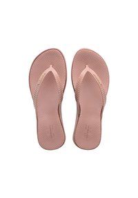 Flip-flop rosa in gomma con una soletta testurizzata, cinghie a strappo affusolate e logo impresso sul lato. Suola piatta progettata per il comfort.