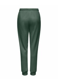 Mørkegrønne joggebukser laget av mykt stoff, med elastisk midjebånd og innsnevrede ben med tettsittende mansjetter ved anklene.