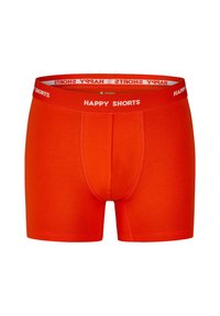 Czerwone bawełniane bokserki o dopasowanym kroju, z białym pasem w talii oznaczonym wyraźnymi literami "HAPPY SHORTS". Gładka faktura i brak wzorów.