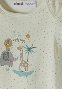 Krémové kojenecké body s puntíky, tropická zvířata (lev, slon, žirafa, krokodýl), palma, slunce a text "malí přátelé z džungle."