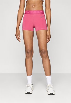Rozā sporta šorti ar "NIKE PRO" jostu. Mīksts, elastīgs materiāls, pieguļošs dizains, gluda tekstūra un logotipa akcenti uz priekša.