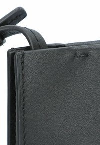 Portefeuille en cuir noir avec une surface texturée, présentant des bords cousus, un système de fermeture à onglet et une doublure intérieure lisse.