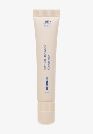Tubo beige de corrector de Radiancia Natural de Korres, con tapa de rosca estriada, texto azul que muestra los detalles del producto, forma delgada y alargada.