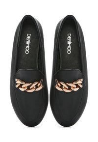 Scarpe slip-on in pelle nera con dettaglio a catena dorata sulla parte anteriore e finitura testurizzata sulla tomaia.