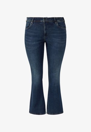 Ciemnoniebieskie dzwony z denimu z talią średniej wysokości, przednimi kieszeniami i kontrastowym przeszyciem. Gładka faktura, dopasowane w udzie.