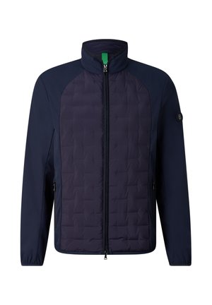 Giacca blu navy con zip, pannello frontale trapuntato, collo alto, tasche laterali con zip e patch con logo sulla manica sinistra.