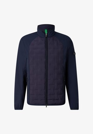 Giacca blu navy con zip, pannello frontale trapuntato, collo alto, tasche laterali con zip e patch con logo sulla manica sinistra.