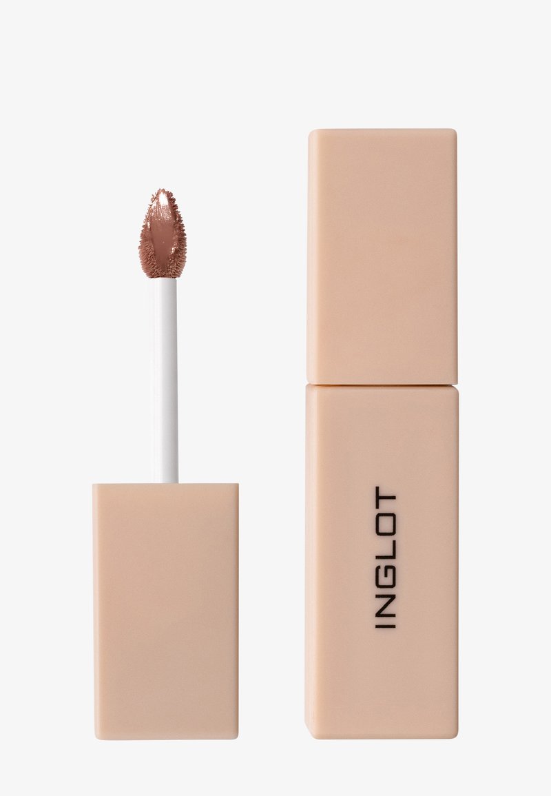 Flytande läppstift i ett fyrkantigt beige rör. Utformat med en vit applikatorborste som har en texturerad topp för exakt applicering.