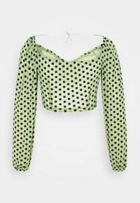Grünes Polka-Dot-Crop-Top mit langen, puffigen Ärmeln und tiefem Ausschnitt. Hergestellt aus transparenter Stoff, mit schwarzen kreisförmigen Mustern durchgehend.
