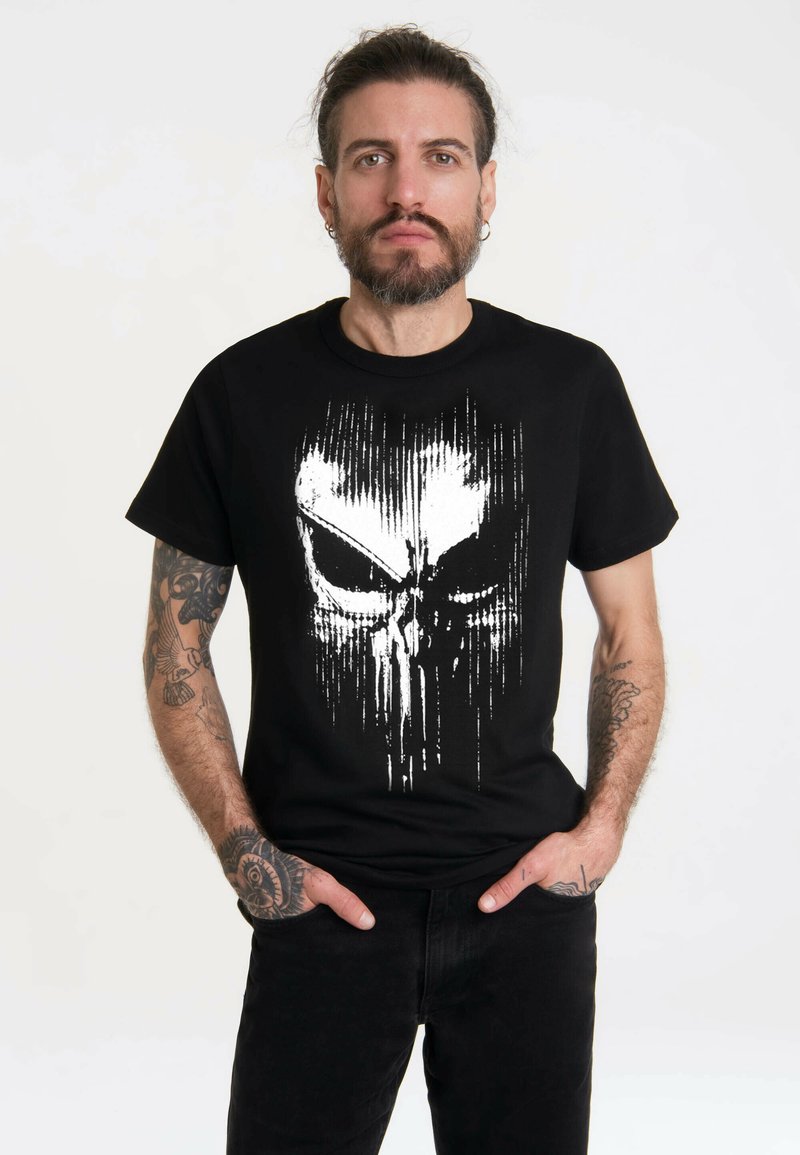 Black cotton t-shirt featuring a white skull graphic with vertical streaks. Short sleeves, crew neck, casual fit, smooth texture.