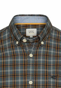 Button-up shirt in dark gray with orange and white plaid pattern. Features a classic collar, two buttons, and a chest pocket with logo.