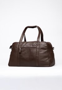 Brown leather duffel bag with twin handles, a zippered pocket on the front, and a smooth texture. Features subtle stitch detailing.