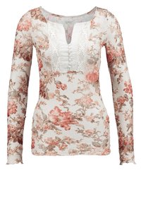 Top a maniche lunghe in tessuto trasparente bianco con stampa floreale in rosa e beige. Presenta un pannello di pizzo parziale e dettagli con bottoni sullo scollo.
