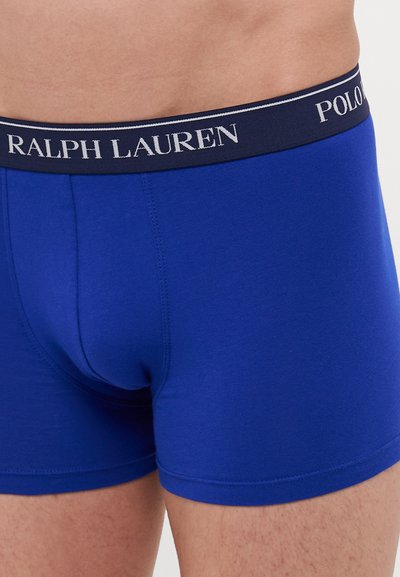 Modri bombažni bokserji z mornarsko modrim pasom, ki vsebuje belo blagovno znamko "RALPH LAUREN" in "POLO". Udobno prilegajoča zasnova z mehkimi vlakni.