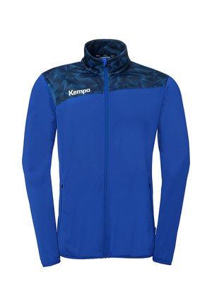 Veste bleue à fermeture éclair intégrale avec empiècement bleu foncé à motifs, col haut, poches latérales et logo blanc "Kempa" sur le côté gauche de la poitrine.