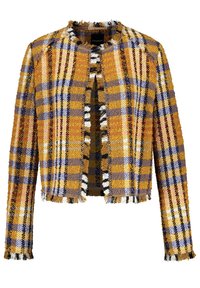 Chaqueta corta multicolor con un patrón de cuadros en amarillo, azul, naranja y negro. Presenta bordes deshilachados y sin cierres.