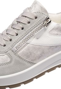 Light grey and white sneaker with fabric laces, side zipper, suede and leather panels, and textured rubber sole.