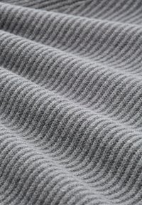 Gray fabric with a textured, diagonal rib pattern, showcasing a soft, woven appearance. Curved folds create depth and visual interest.