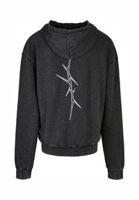 Sweat à capuche noir court en tissu doux, avec capuche, poignets côtelés et une broderie abstraite blanche au dos.