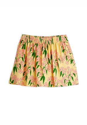 Floral skirt made from a lightweight, yellow fabric featuring pink flowers and green leaves. Elastic waistband provides a gathered silhouette.