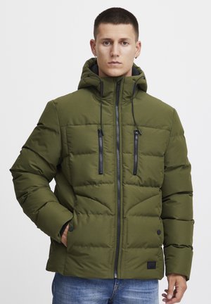 Olive green puffer jacket with a hood, zippered front, and two chest pockets. Textured fabric with stitched sections for insulation.