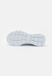 White rubber shoe sole with textured grip pattern, featuring horizontal and vertical ridges, and a smooth rounded toe area.