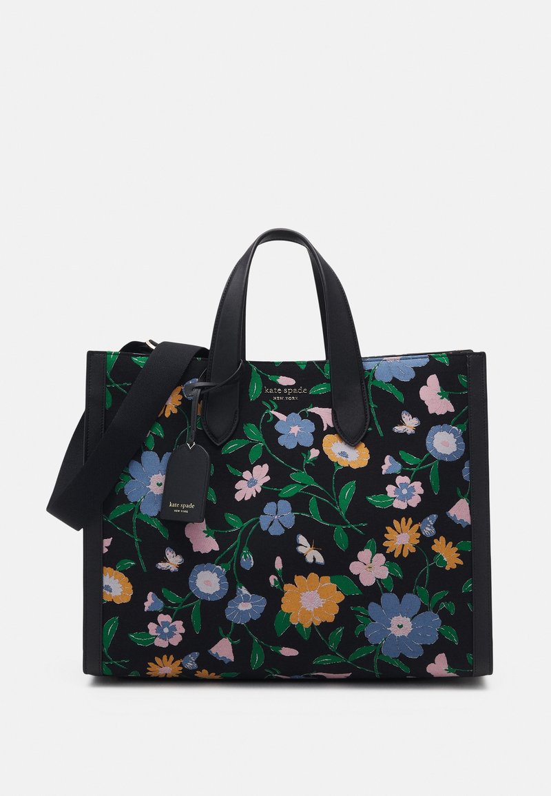 Sac à main rectangulaire noir avec imprimé floral coloré, deux poignées, une bandoulière amovible et une petite étiquette de marque suspendue à une poignée.
