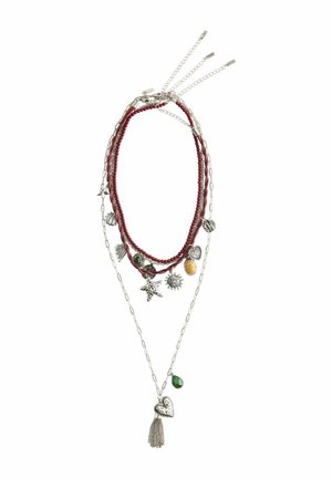 Layered necklace with red beads, silver chains, and various charms including stars, hearts, a sun, a yellow oval stone, and a green teardrop stone.