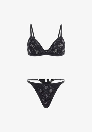 Black bikini set featuring a triangle bralette and thong, adorned with silver flower patterns and studs. Adjustable straps included.