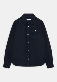 Marinblå kordflosshirt med knapp-down krage, framfickor och knäppning. Mjuk textur och långa ärmar med rundad nederkant.