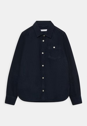Chemise en velours côtelé bleu marine avec un col boutonné, une poche avant et un système de fermeture à boutons. Texture douce et manches longues avec un ourlet arrondi.