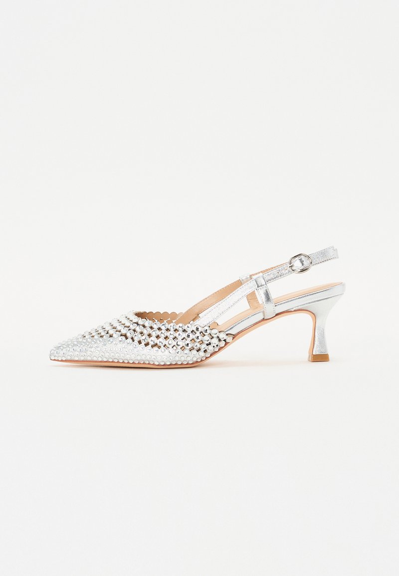 Silver slingback high-heeled shoe with pointed toe, embellished with circular studs, and a textured upper. Features a slender heel and strap.