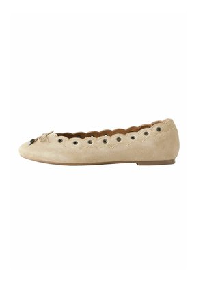 Beige suede flat shoe with scalloped edges, metal eyelets along the upper, and a small bow at the front, viewed from the side.