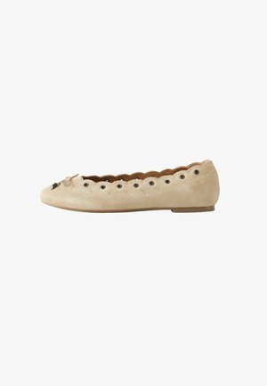 Beige suede flat shoe with scalloped edges, metal eyelets along the upper, and a small bow at the front, viewed from the side.