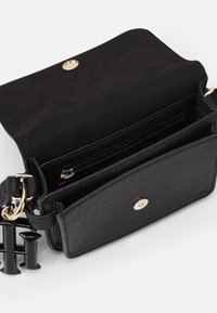 Czarna torebka na ramię z teksturowanej skóry, wyposażona w złote zapięcie na zatrzask oraz wewnętrzną kieszeń na suwak. W komplecie regulowany pasek.