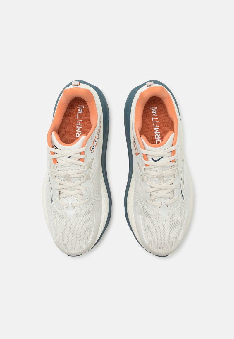 Baskets de sport blanches avec une partie supérieure en mesh respirant, des accents orange clair et une semelle bleu foncé. Présente un design arrondi et des détails texturés.
