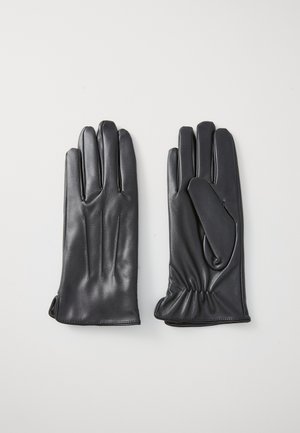 Une paire de gants en cuir noir, l'un face paume vers le haut montrant les coutures du pouce et le poignet élastique, l'autre paume vers le bas avec des détails de couture simples.