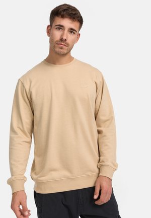 Beige crew-neck sweatshirt made of soft fabric, featuring ribbed cuffs and hem. Small logo detail on the left chest. Relaxed fit.