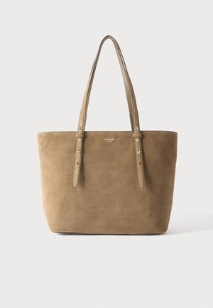 Medium brown suede tote bag with two adjustable shoulder straps and small white "kate spade new york" logo on front.